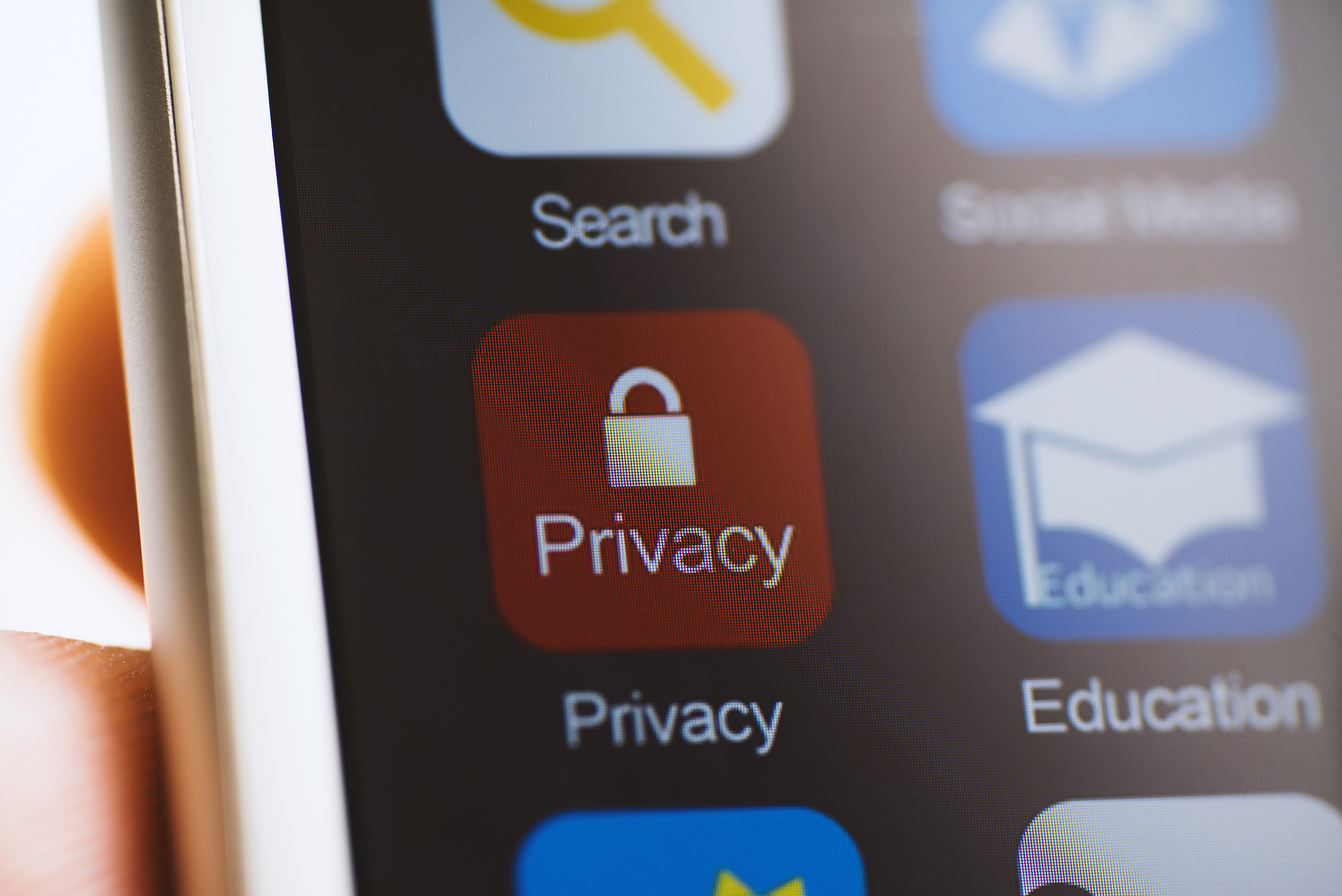 hand holding phone, privacy app on screen