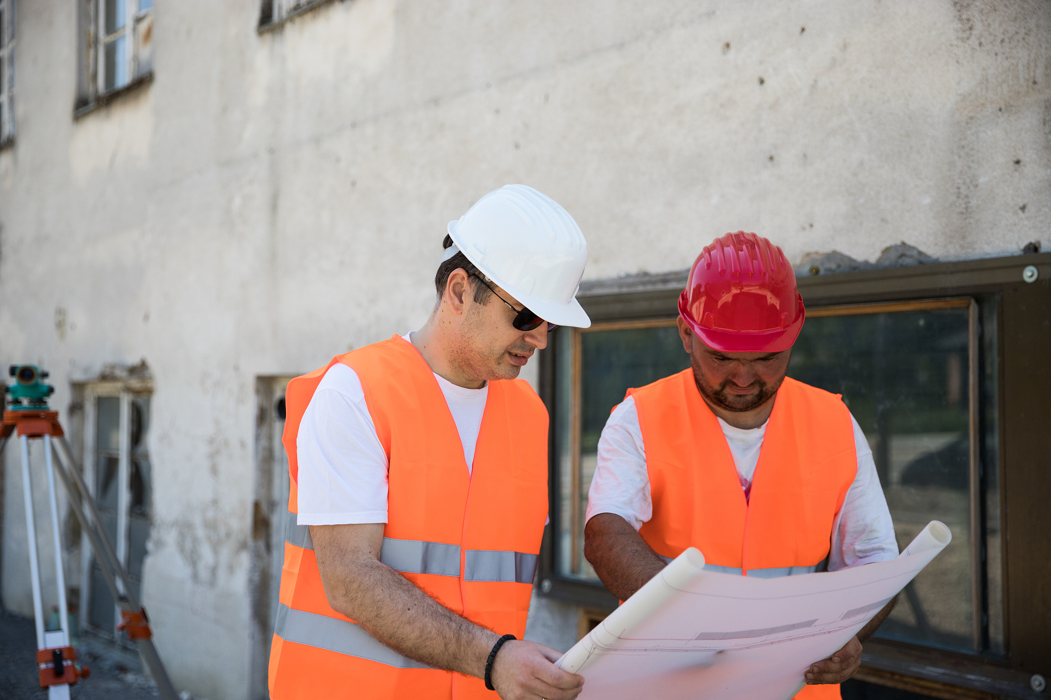 construction workers reviewing blueprint together