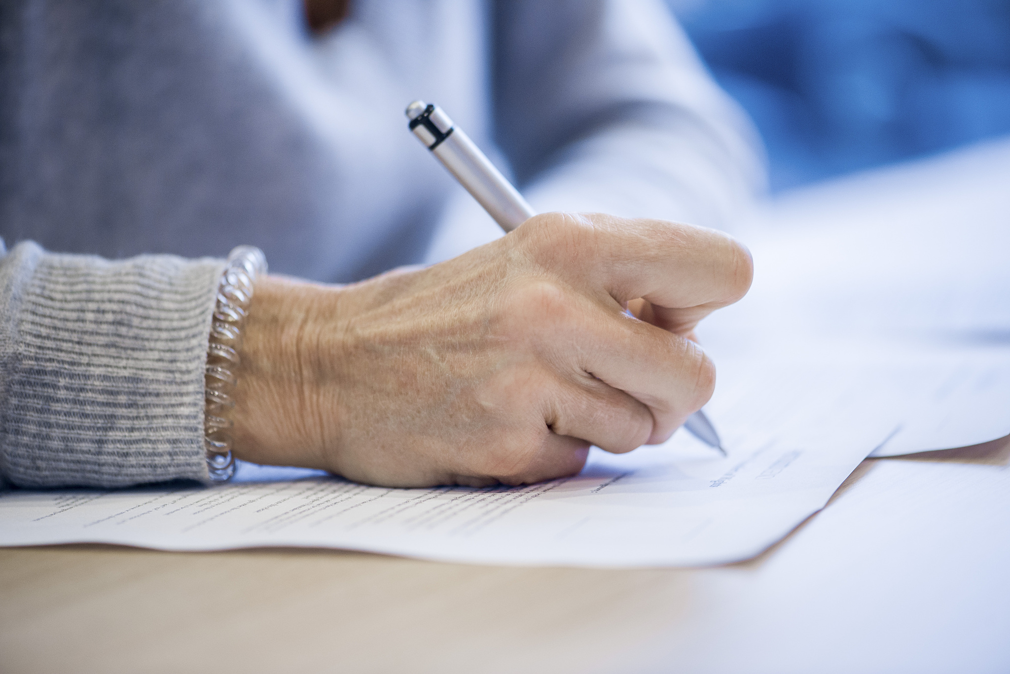 close-up of businesswoman signing document