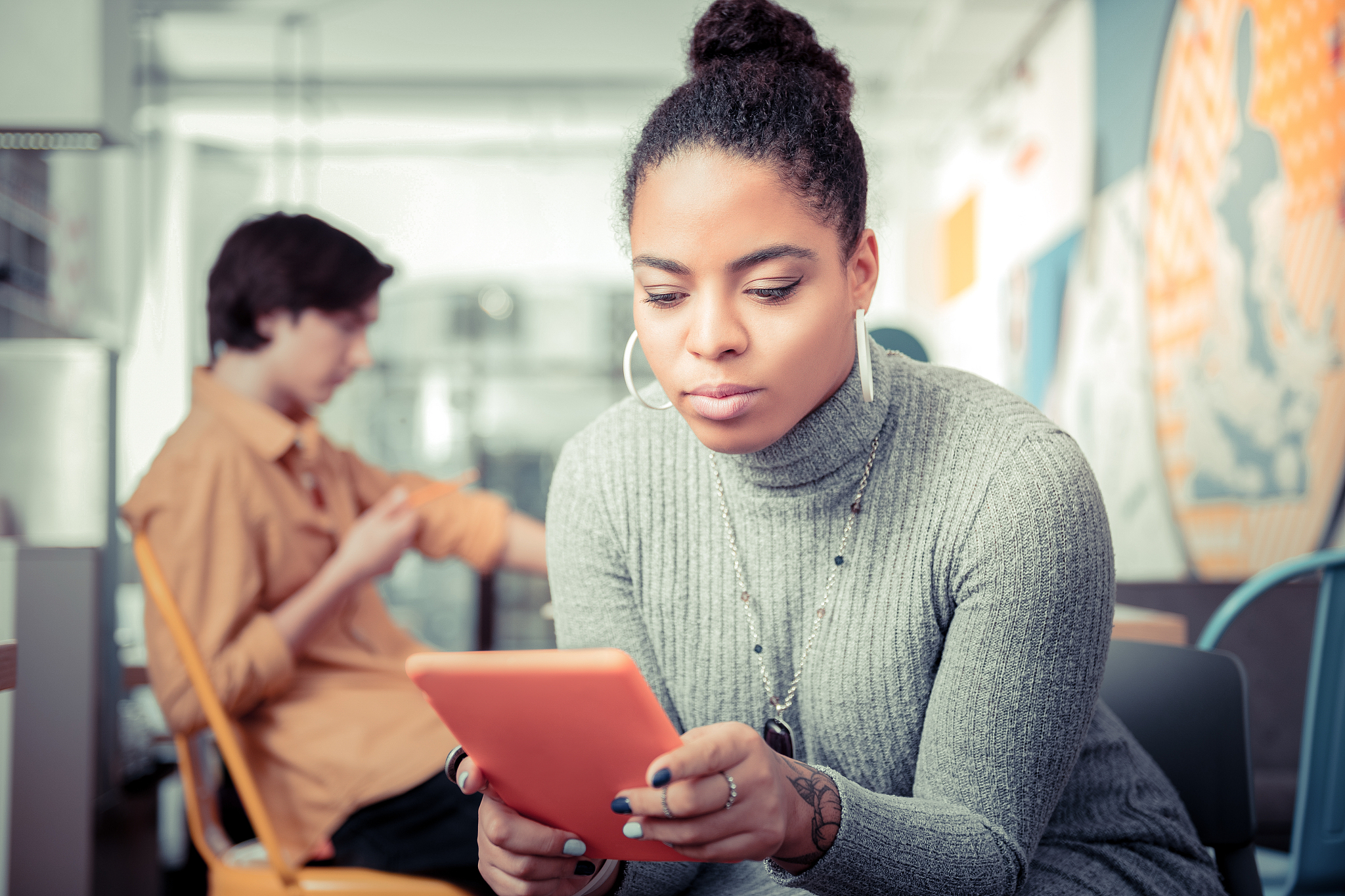 young woman gripped with texting and not noticing her friend