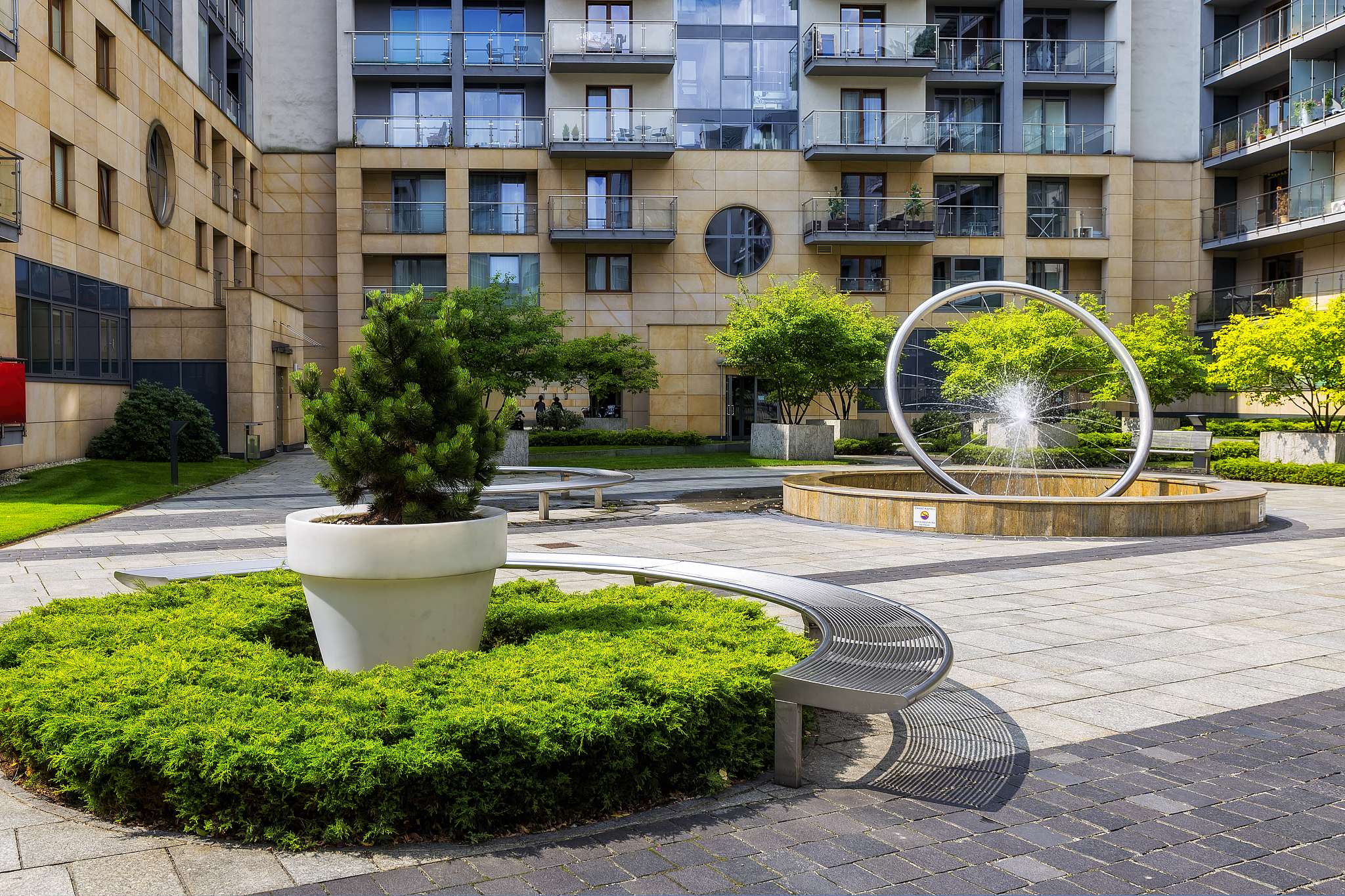 green square with bench in front of modern housing estate