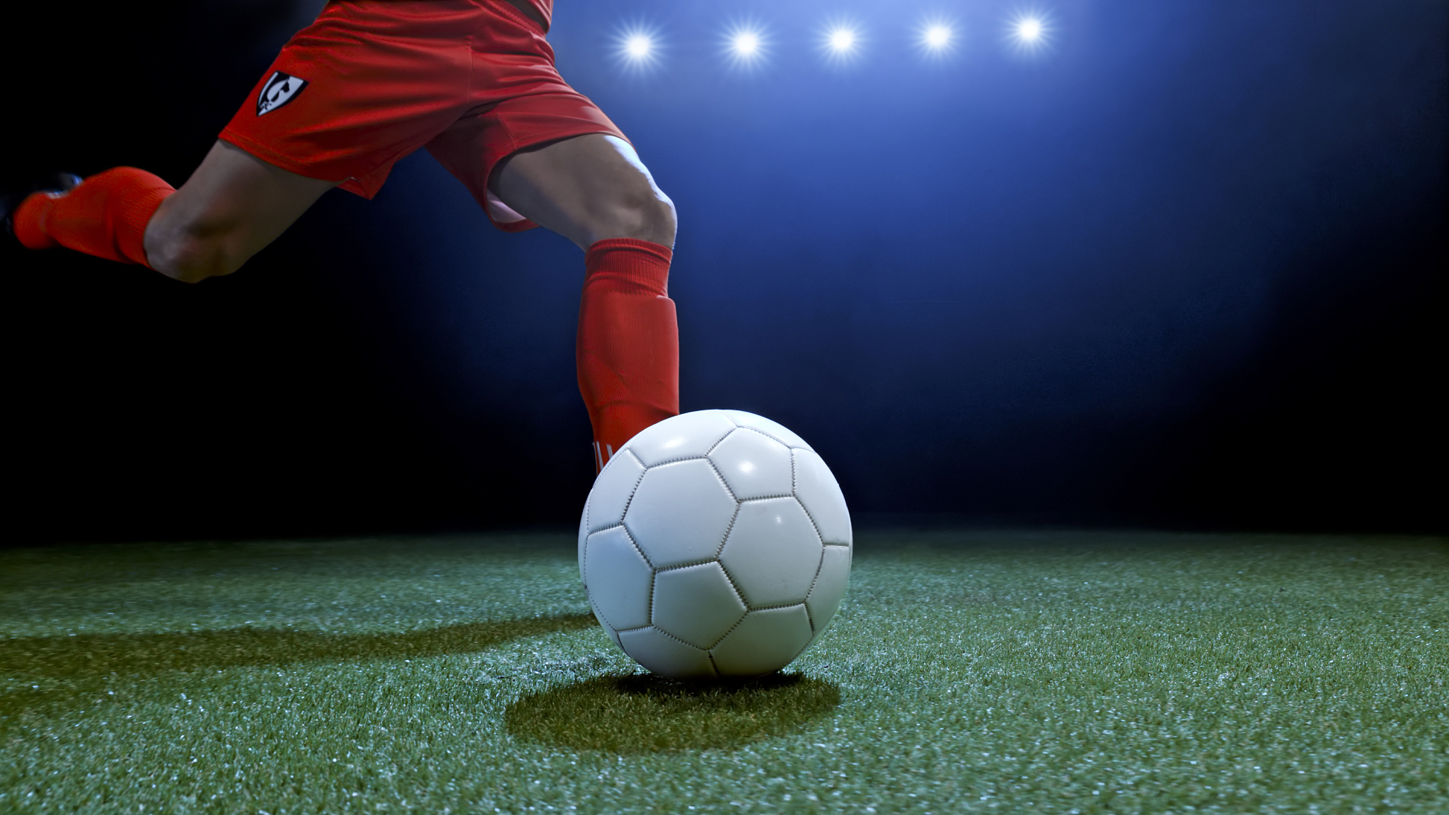 male football player kicking ball