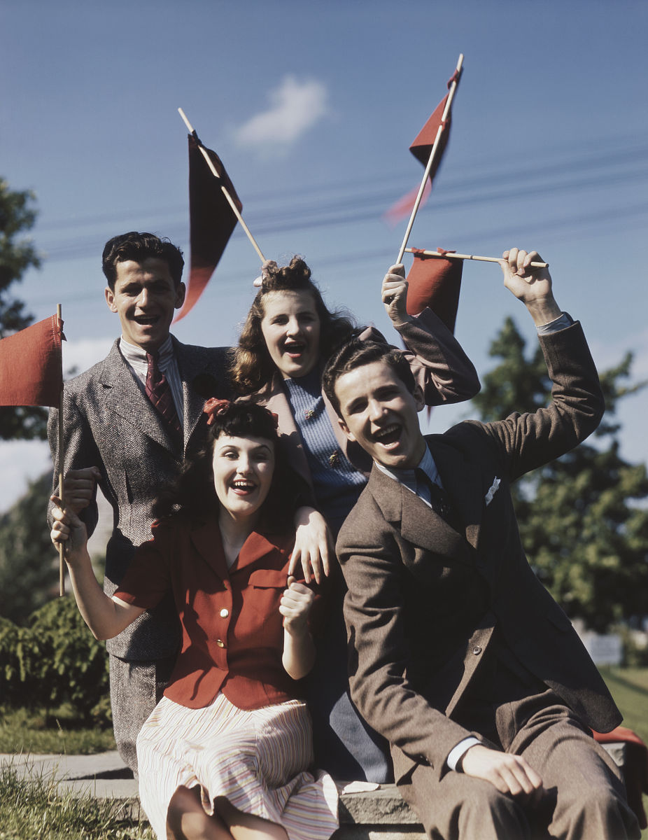 people cheering with flag