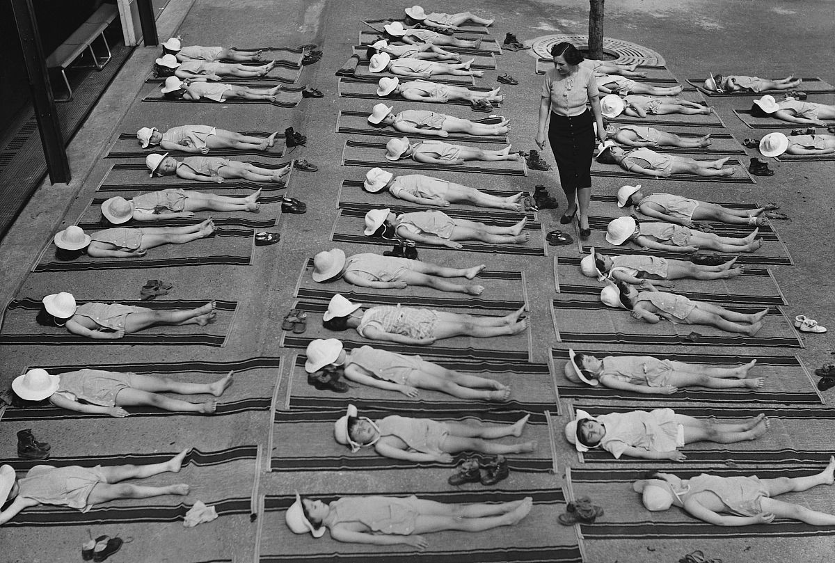 school children sunbathing as a set part of their curriculum. su