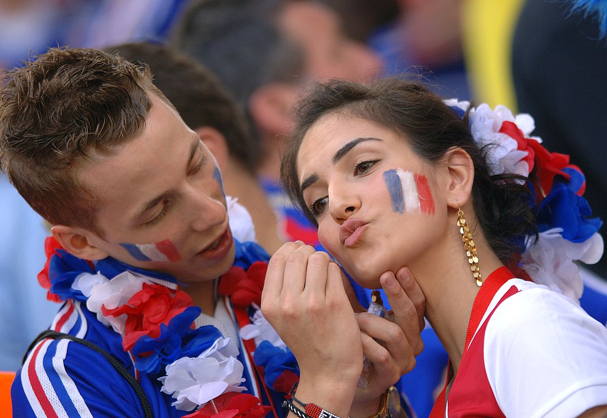 france fans paint each other faces in the style of their nationa