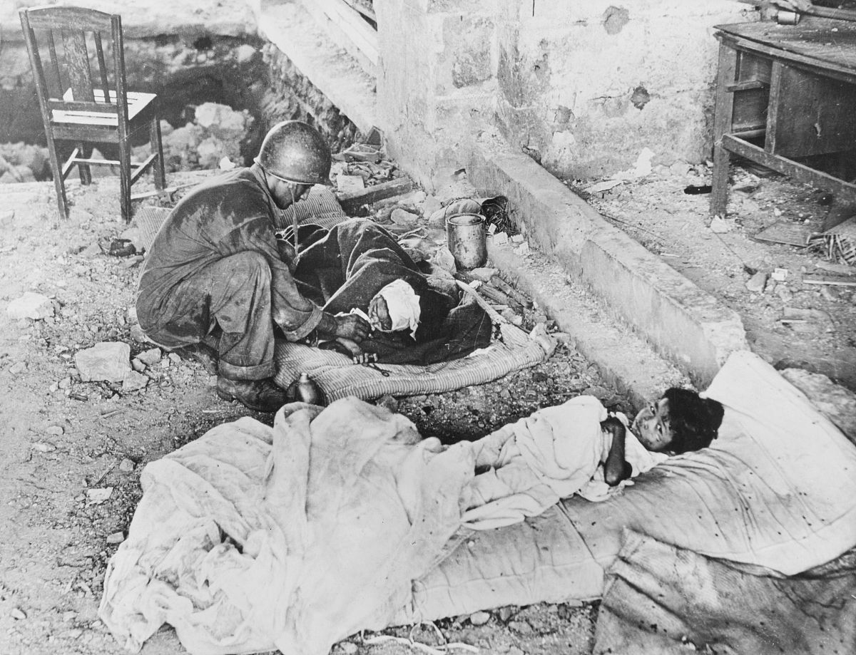 a medical corpsman of the united states sixth army gives water t