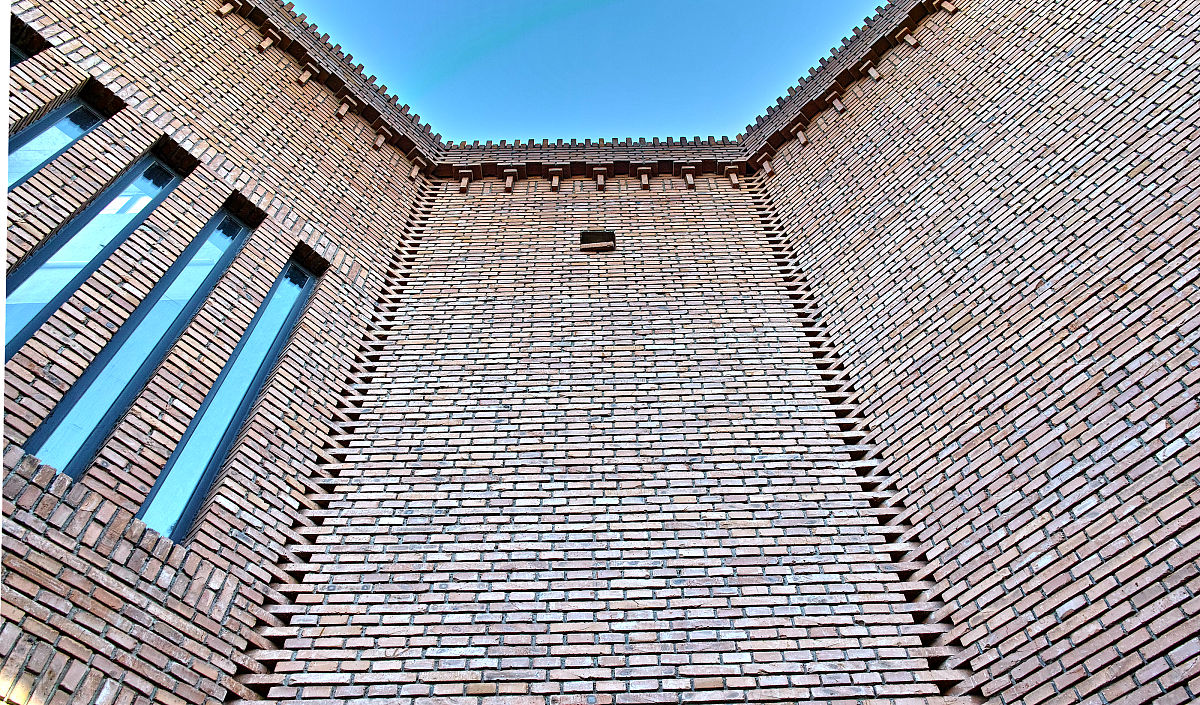 请把下面的中文翻译成英语：如果房屋是建在旧屋基上则在祭祀仪式之后要先把陈旧的土石去掉并根据需要填充新土或挖到新土层。假如是在烧毁了的旧屋基上新建房屋那么 还得举行一堂耕基的巫事。这堂巫事需要一头大黄牯 一段红布一只红公鸡一些酒食以及香蜡纸烛末了 主持法事的巫者要驾牛犁屋基一共三个来回。