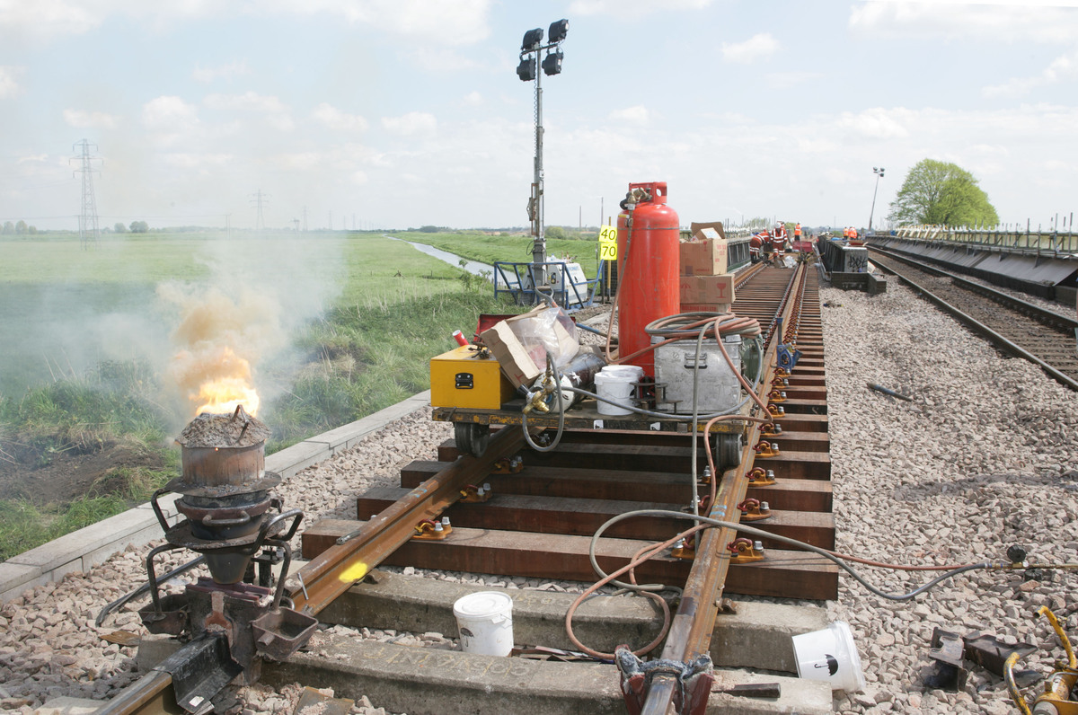 中文润色简写：为了减少高速列车在高寒地区运行时转向架表面出现过多的积雪本文根据转向架舱形状和制动夹钳相对位置设计了两种主动吹气方案采用非定常雷诺平均算法与离散相模型耦合的方法对列车底部的风雪流进行计算以探究主动吹气对转向架区域的防雪效果。研究结果表明主动吹气改变了转向架区域的流线上扬现象使得列车底部的气流向外侧流动同时携带大量雪粒离开转向架区域。吹气提高了转向架表面的摩擦风速雪粒所受剪切力增加从而