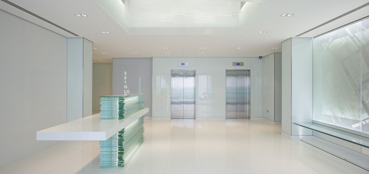 view of reception with sculptured glass reception desk, anchor h