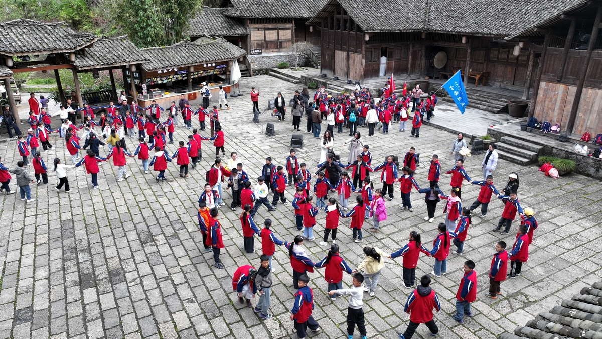 2026年3月30日,重庆酉阳,小学生在非遗传承人的指导下