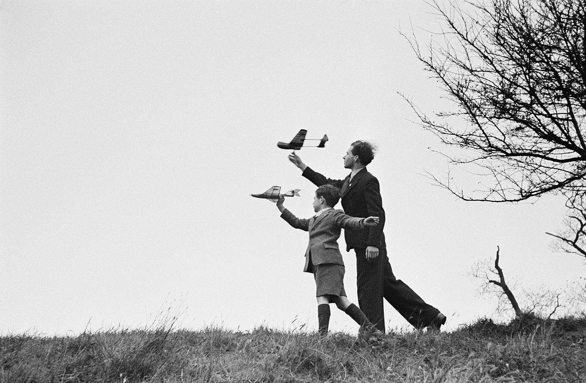a man and boy flying model aircraft together, <strong>1</strong>951.