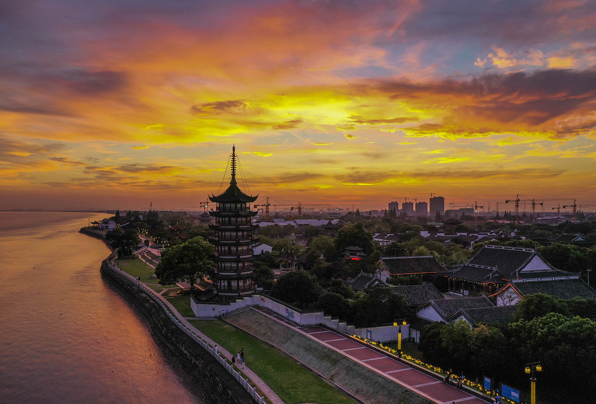 2021年7月13日傍晚,浙江嘉兴,海宁盐官钱塘江畔,晚霞染红了天边,将占