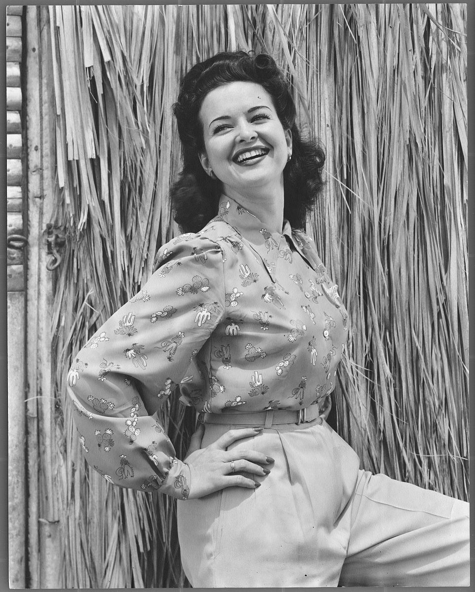 actress mapy cortes standing by thatched hut (photo by  john spr
