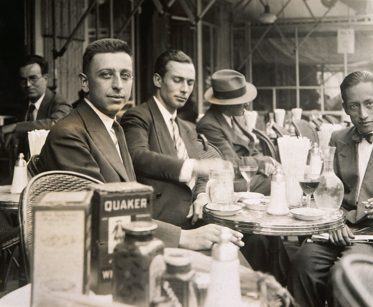 french surrealist poet robert desnos (left foreground) sits at a