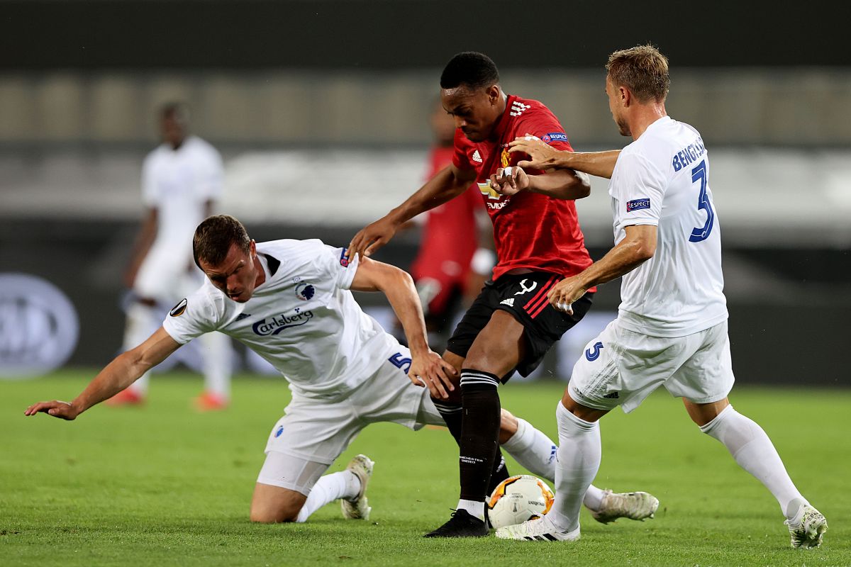 manchester united's french forward anthony martial (c) vies with