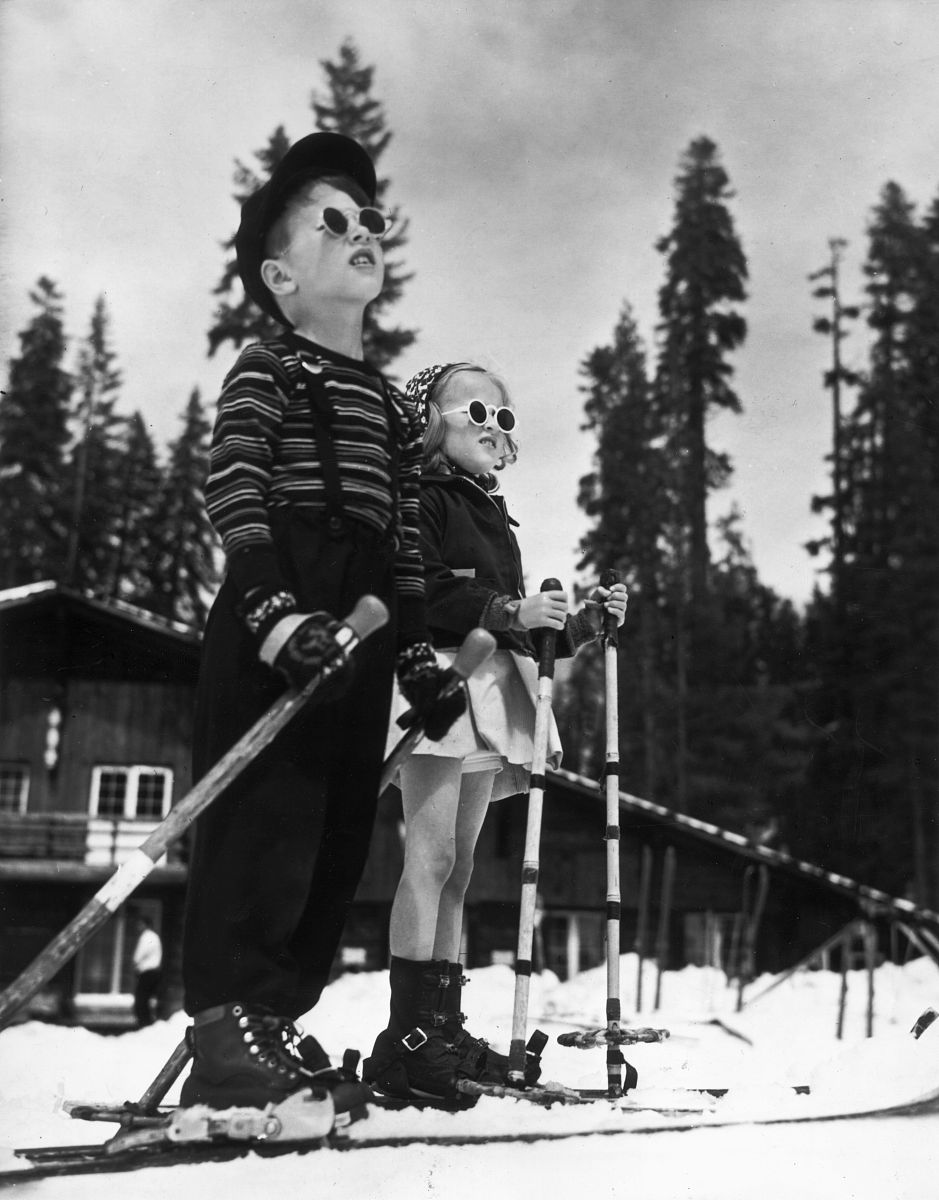 circa 1955:  full-length image of a boy and a girl standing on s