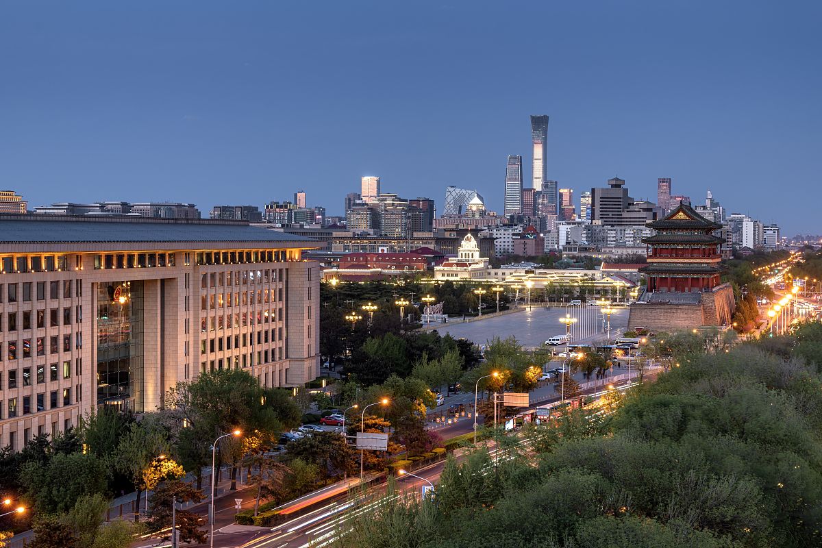 2021年4月13日,北京,在前门大街远眺正阳门和远处的国贸cbd夜景.