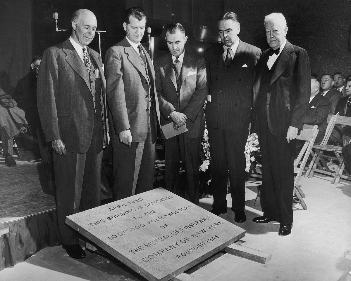 april 1950:  five men stand around a dedication plaque, new york