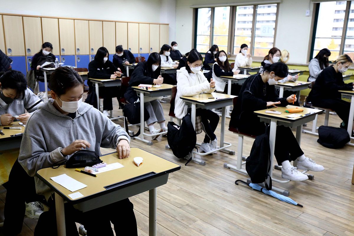 当地时间2021年11月18日,韩国首尔,考生们相继进入考场.韩国2022学年