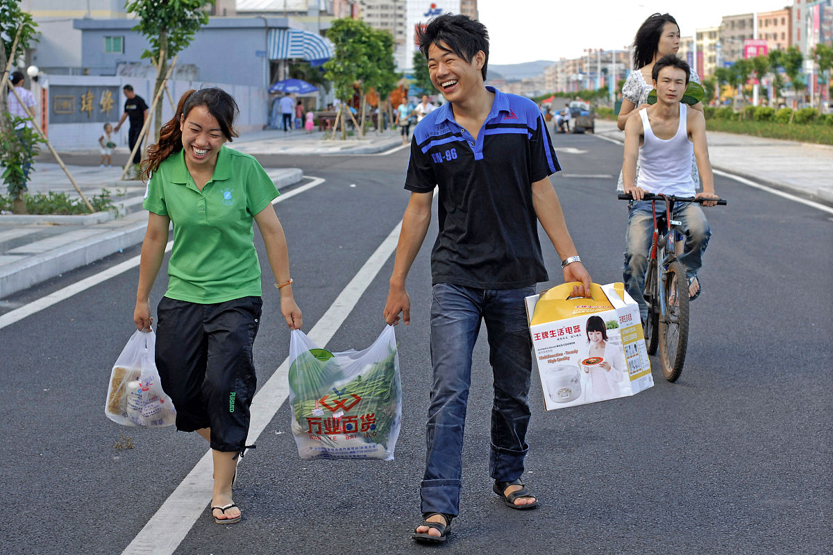 2010年08月01日,广东东莞长安镇,打工者从市场买东西后返回出租屋.