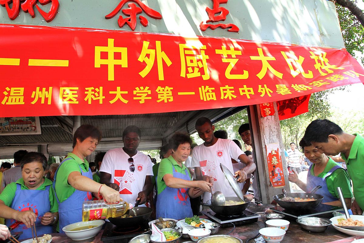 2013年7月11日,浙江温州,市民嘴里塞满的中外风味的菜肴,一时分不清哪