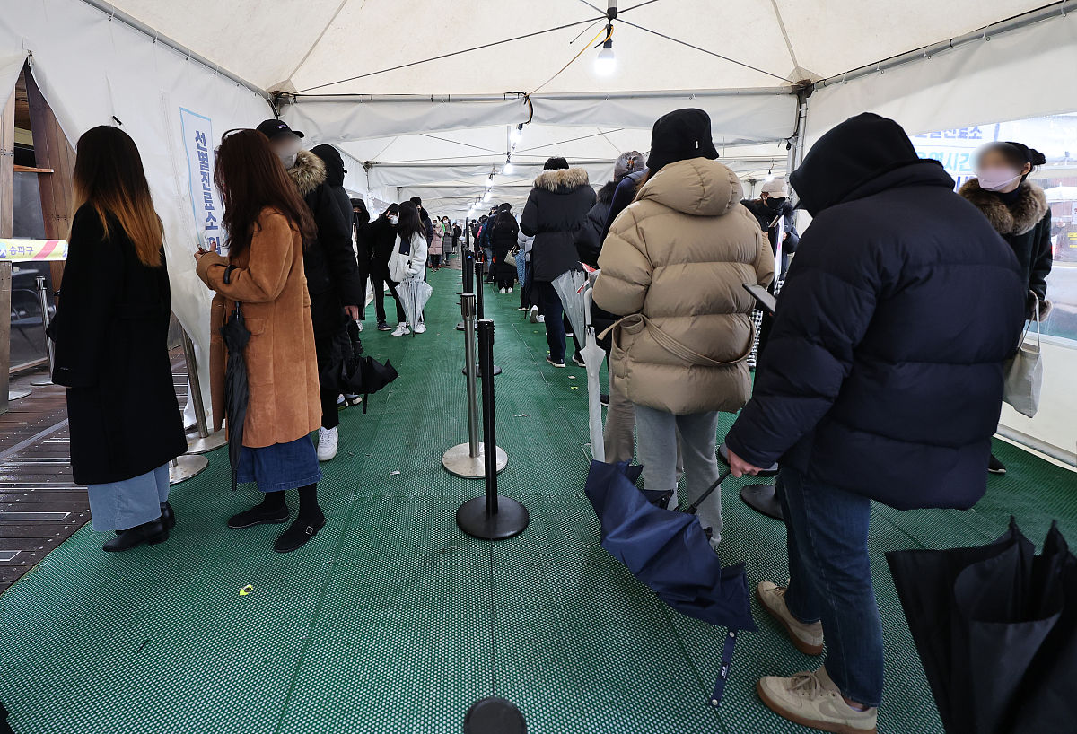 当地时间2022年1月25日,韩国首尔,当地民众排队进行新冠检测.