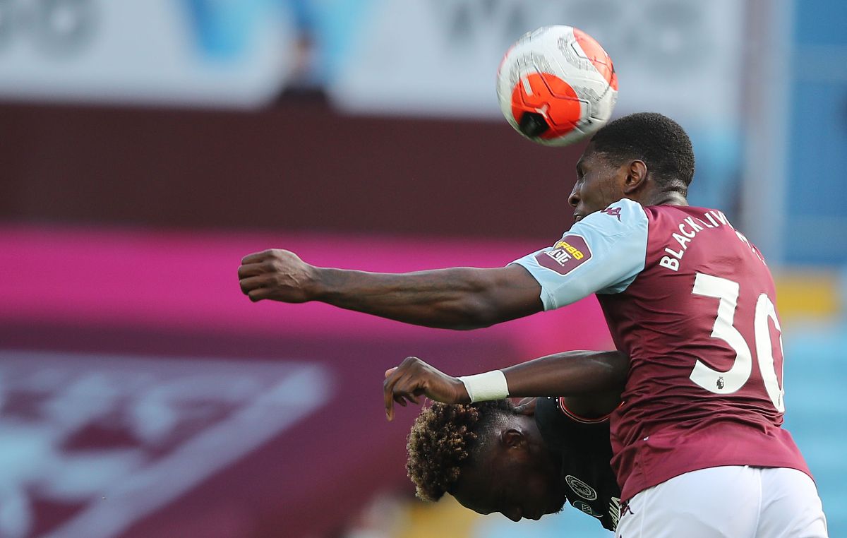 aston villa's english defender kortney hause (r) jumps for the b