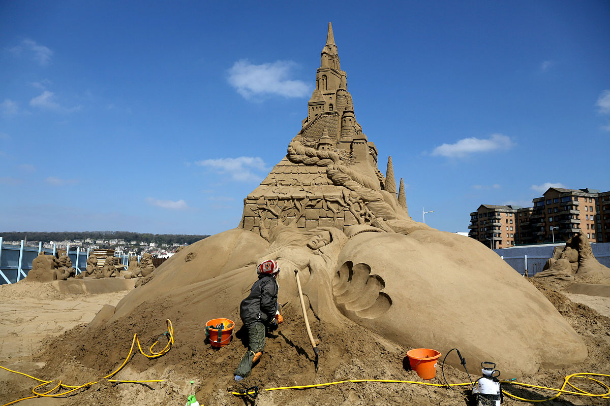 当地时间2014年4月16日,英国滨海韦斯顿,沙雕艺术家对作品进行最后的
