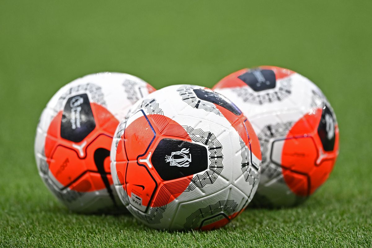 footballs on the pitch ahead of the english premier league footb