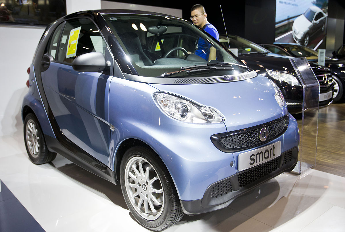 2013年8月9日,北京,观众在展会上了解梅赛德斯smart轿车.