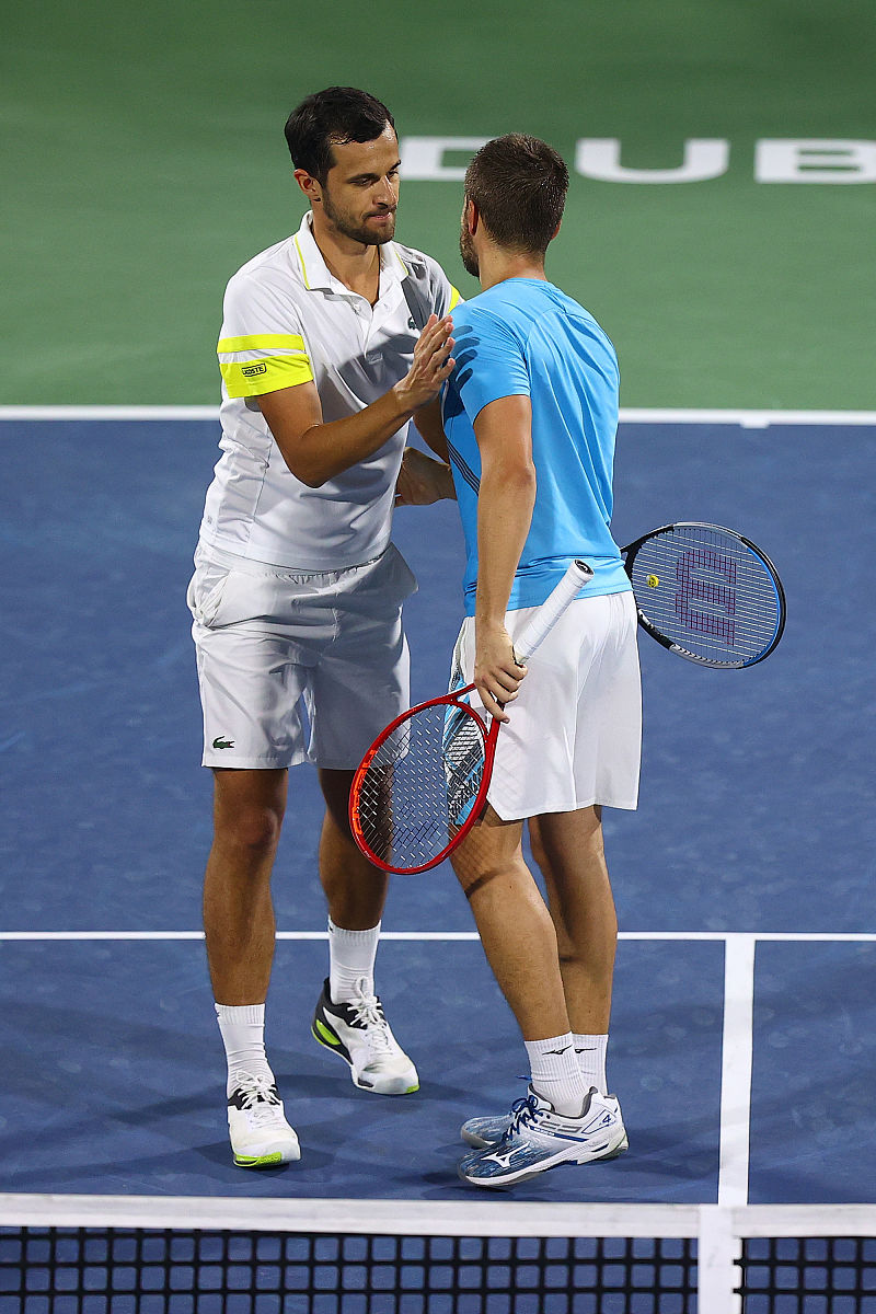 dubai, united arab emirates - march 19: mate pavic (l, white t s