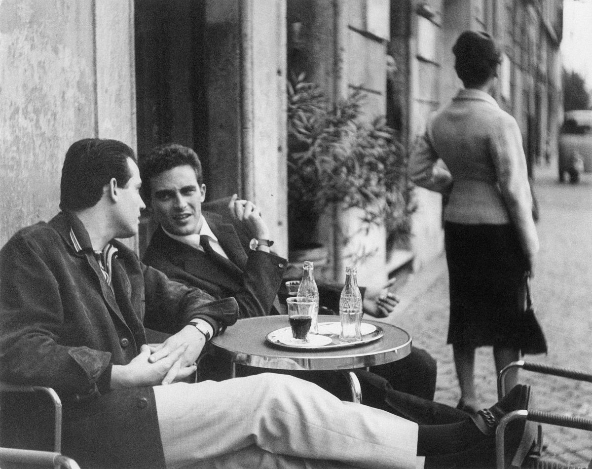 (double rates apply) two men chatting at the outdoor table of a 
