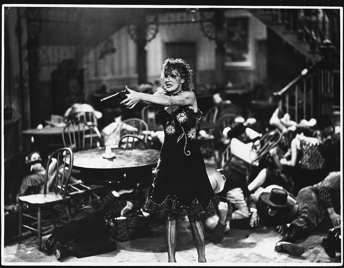 marlene dietrich points a gun in a scene from the western destry