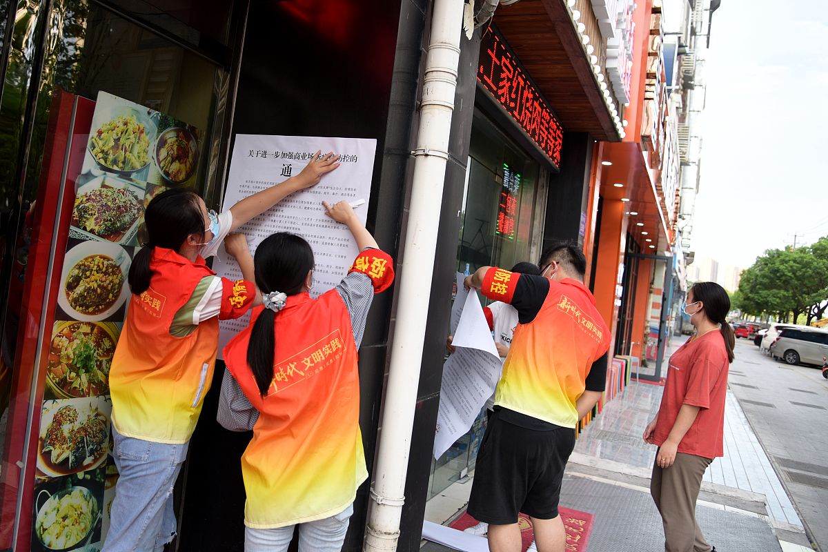 2021年7月31日,江苏如皋,如城街道城南社区管辖区域,大学生志愿者在商