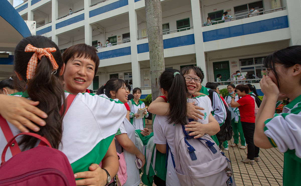 2021年6 月7日,在位于海南省琼海市嘉积中学考点,老师和考生们一起聊
