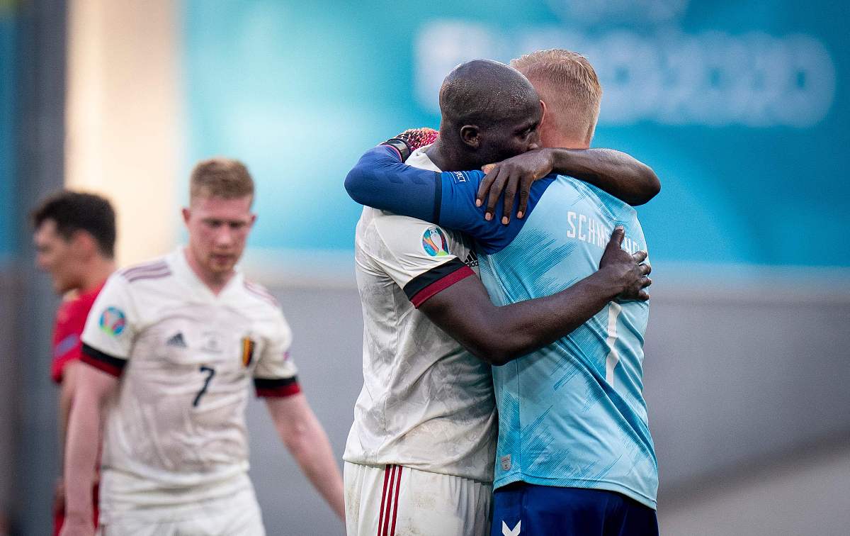 denmark out. belgium's forward romelu lukaku (c) hugs denmark's 