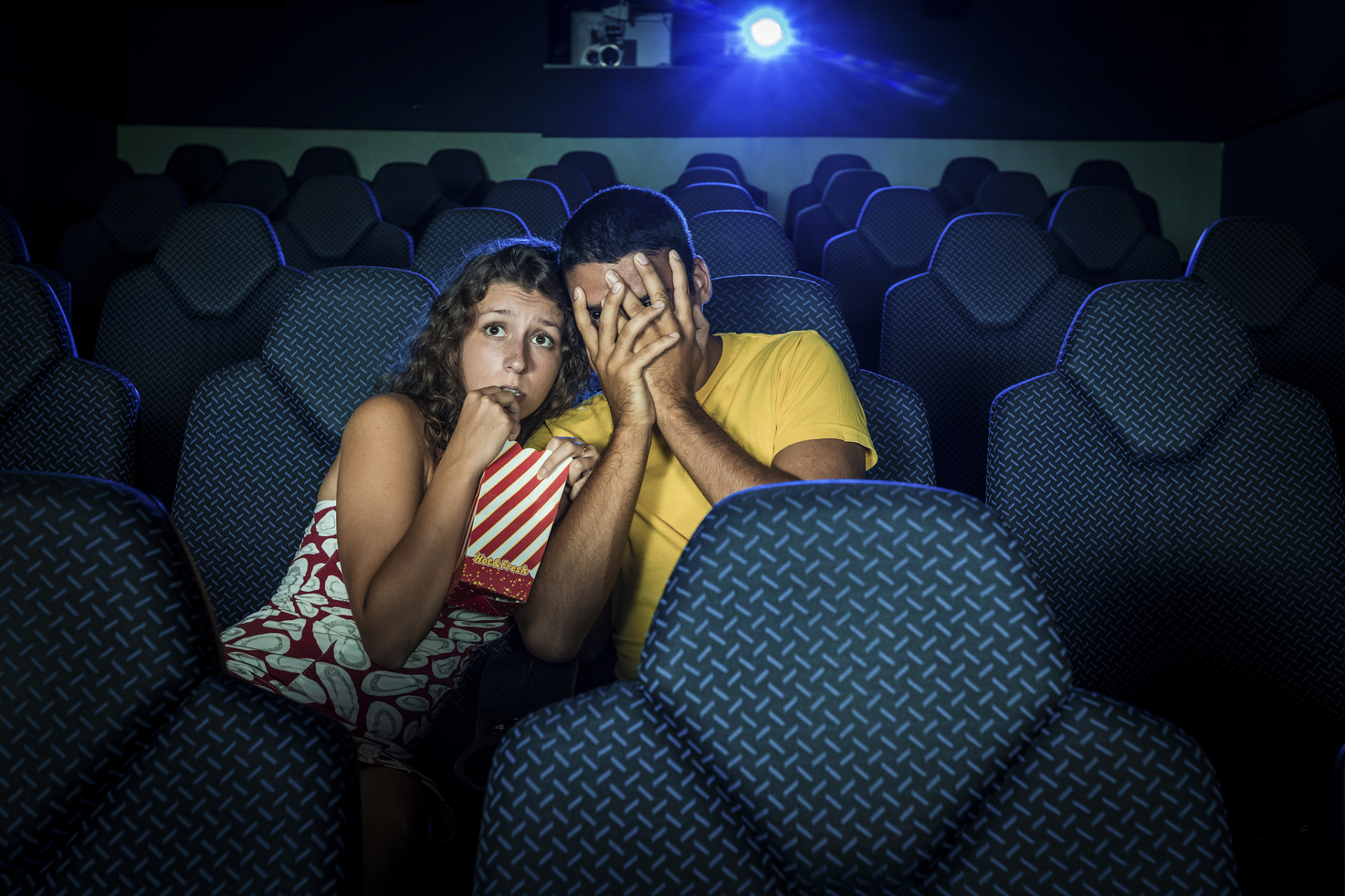 一对情侣在电影院里看电影. 女友对男友说:"你看起来很紧张.