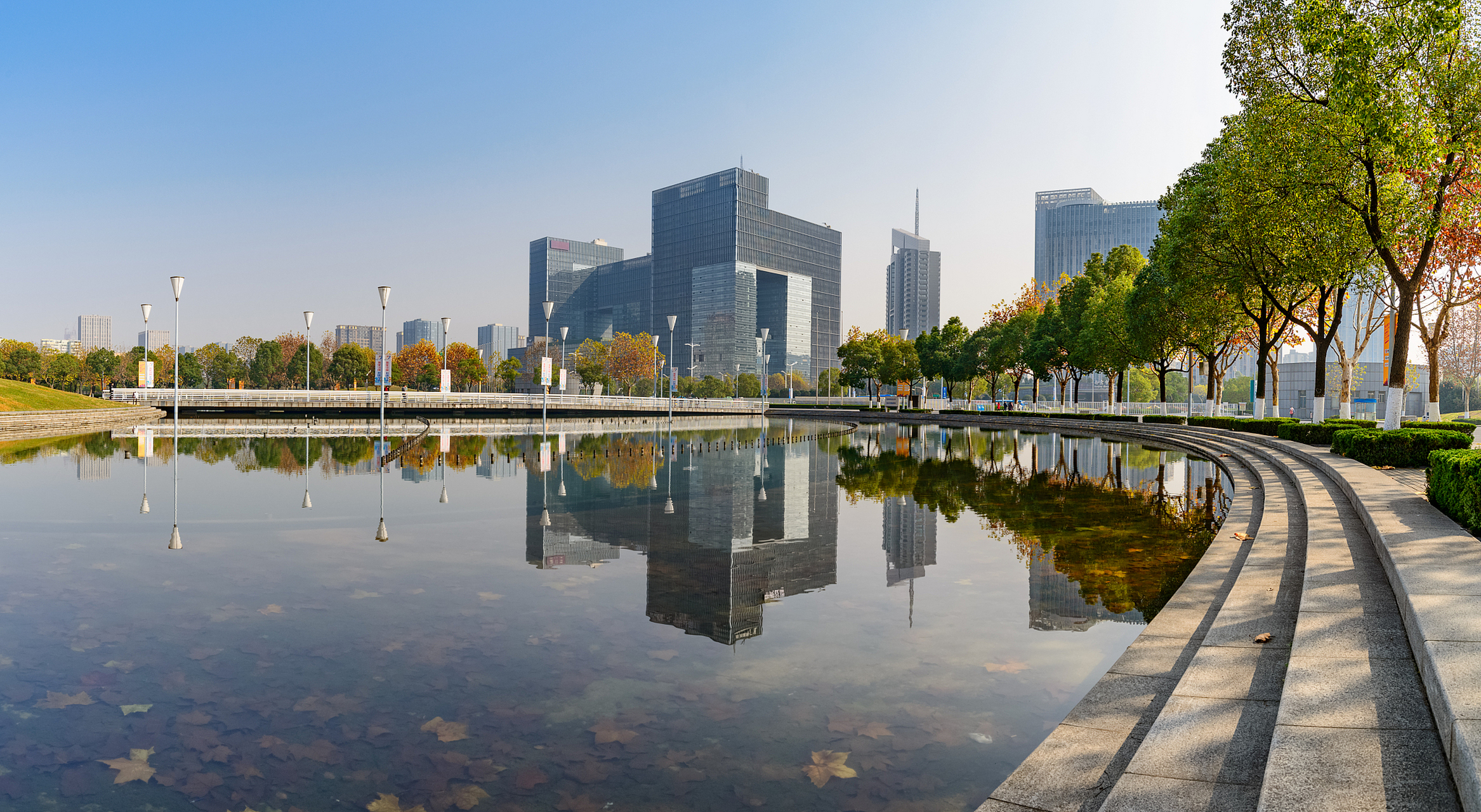 从远处望去,如意湖宛如一面明镜,倒映着周围的高楼大厦和绿树成荫.